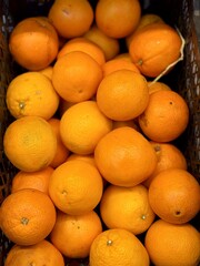 Box with ripe fresh oranges on the shelf of a fruit supermarket are displayed for sale