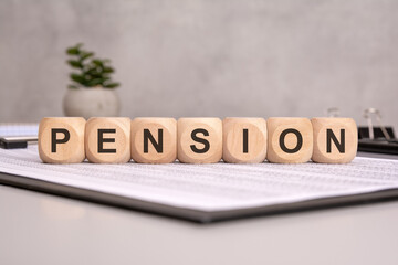 Fototapeta premium letters of the alphabet of pension on wooden cubes