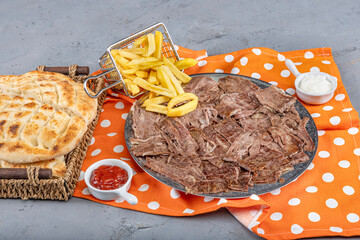 Doner kebab on a gray wooden background. Traditional Turkish cuisine delicacy meat doner. Meat...