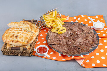 Doner kebab on a gray wooden background. Traditional Turkish cuisine delicacy meat doner. Meat...