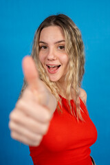 Young woman smiling and giving a thumbs up