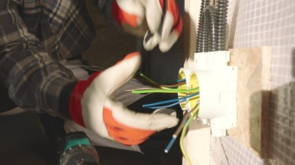 Skilled Electrician Performs Wiring Installation in Home Renovation Project