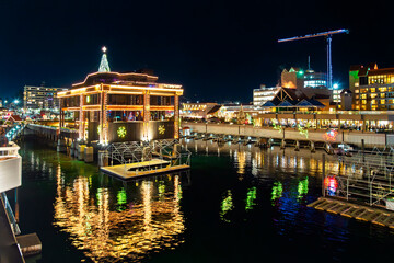 Colorfully decorated illuminated holiday buildings along Lake Coeur d'Alene at Christmas in the...