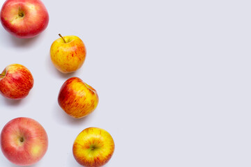 Variety of fresh apples on white background.