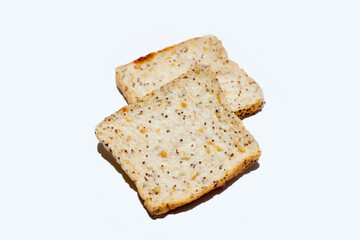 Whole grain bread slices on blue background.