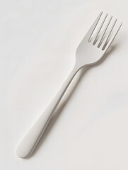 Simple white fork resting on a light surface ready for dining experience