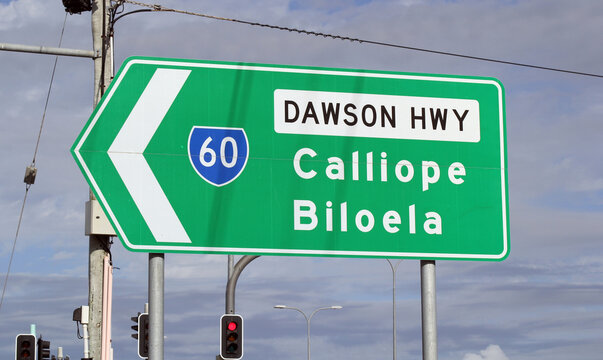 Green road sign pointing towards Calliope and Biloela on the Dawson Highway in Gladstone, Queensland, Australia