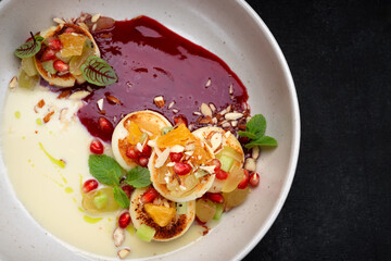 Fried cheesecakes with sauce and pieces of fruit