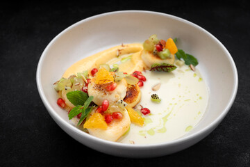 Fried cheesecakes with sauce and pieces of fruit