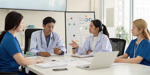 Medical team analyzing patient data and discussing treatment plans in a meeting.