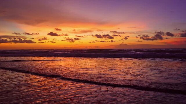 Tropical sea at sunset or sunrise over sea video 4K, The sun touches horizon, Red sky in golden hour amazing seascape,Ocean beach sunsets,The sun in spindrift clouds Fantastic natural sunset