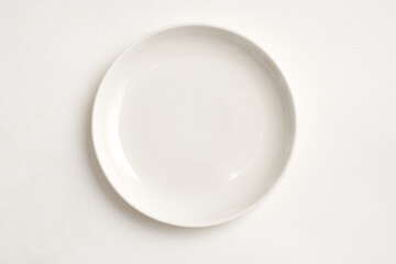 Round white plate isolated on white background.