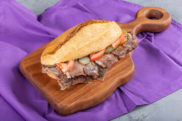 Meat doner between bread on a wooden plate. Traditional Turkish cuisine doner. Meat doner between...