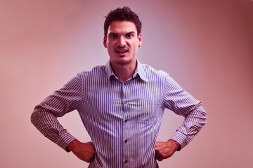 Young businessman showing dominance with hands on hips