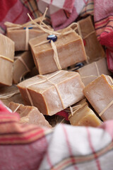 Beautiful handmade soaps wrapped in natural fibers in a basket