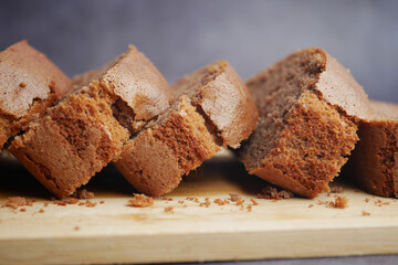 Freshly baked brown bread laid on a wooden cutting board