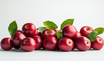 A vibrant arrangement of fresh red apples with green leaves on a clean white background