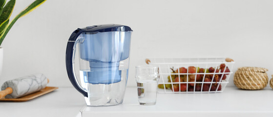 Water filter pitcher and glass on kitchen counter