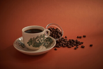 Nanyang kopitiam style coffee in vintage cup and saucer. Orange background and selective focus.