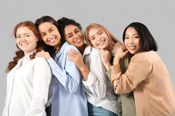 Beautiful young happy women on grey background. Women history month