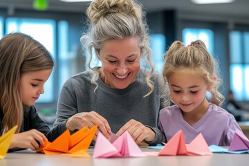 A teacher guiding students through an origami craft activity, colorful paper on the table