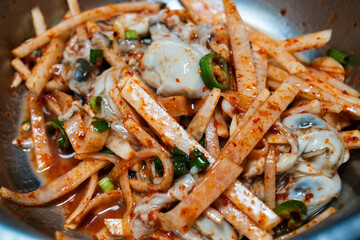 raw oysters seasoned with spicy sauces, vegetables and other ingredients