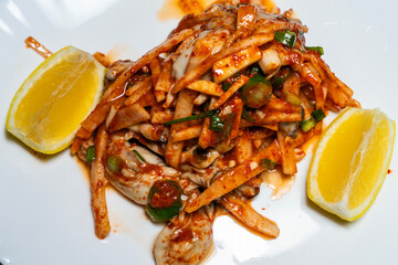 lemon, and raw oysters seasoned with spicy sauces and vegetables