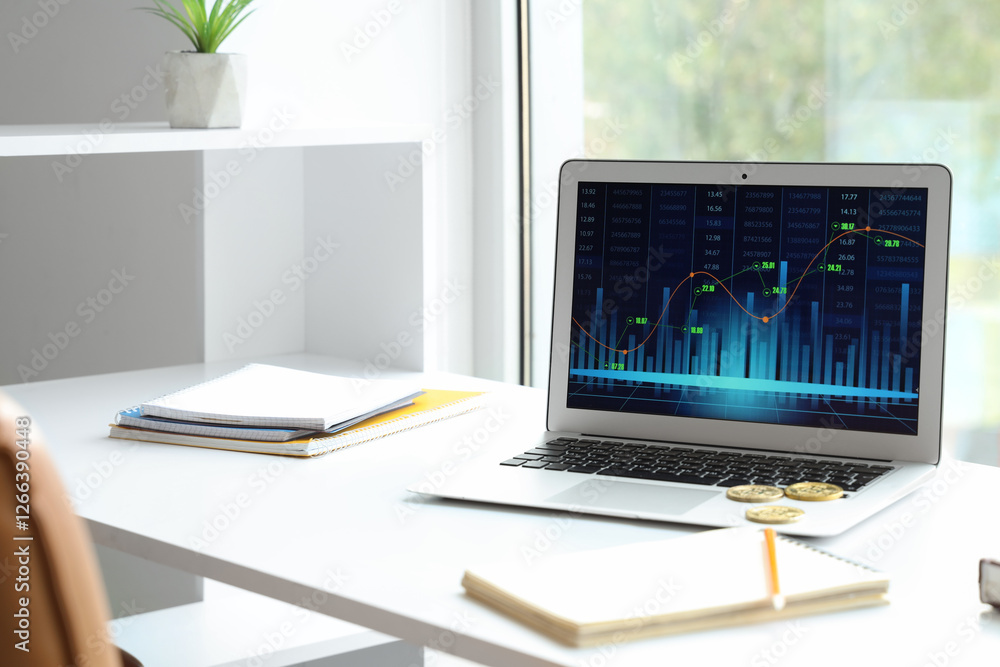 Poster laptop with stock data on trader's table near window in office