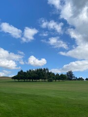golf course with blue sky and clouds