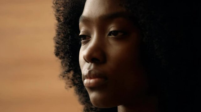  Woman with Curly Hair in Soft Lighting