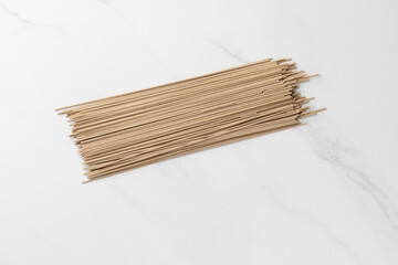Dry soba noodles on a marble background. Asian food and healthy eating. 