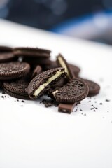 Naklejka premium Delicious Chocolate Sandwich Cookies Crumbled on White Background