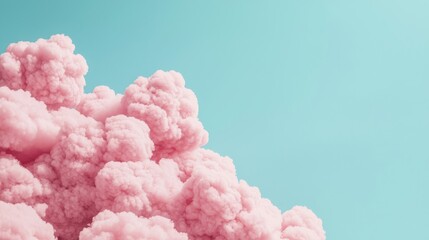 A vibrant image of fluffy pink clouds against a pastel blue sky, perfect for dreamy backgrounds and design projects.