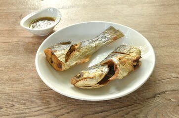 deep fried salty tiger fish dipping Thai spicy seafood sauce on plate