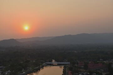sunset into mountain at Khun Dan Prakarn Chon huge concrete dam in evening on Thailand 