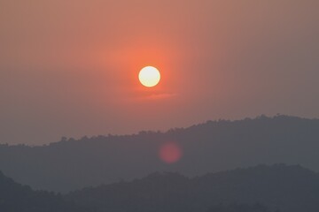 sunset into mountain at Khun Dan Prakarn Chon huge concrete dam in evening on Thailand 