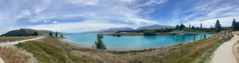 Fototapeta premium blue lake green hills cloudy skies