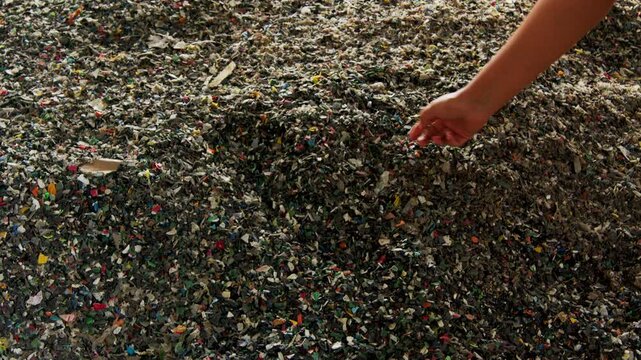 Closeup footage of a bunch of microplastic trash in a recycle facility