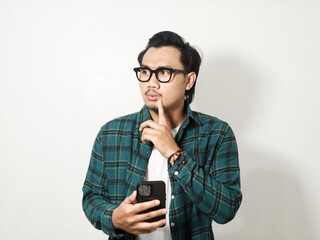 Adult Asian man holding his mobile phone with happy expression isolated on white background