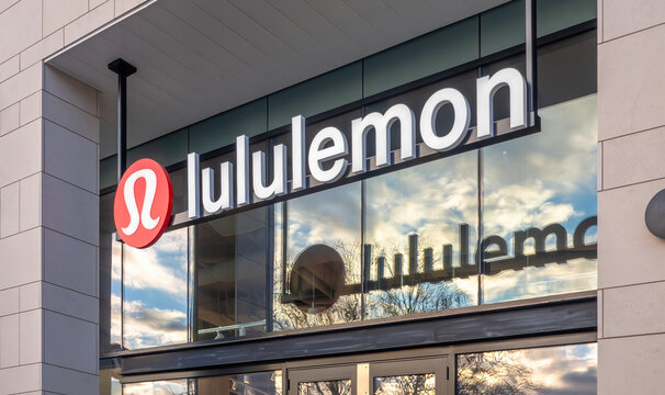 Victoria, British Columbia, Canada. Feb 14, 2025. Lululemon storefront with prominent logo and clear signage against a light stone facade, reflecting the sky and trees in the glass.