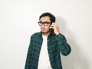 Asian man showing sad expression when answering a phone call isolated on white background