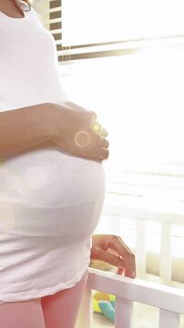 Pregnant woman looking at new cot