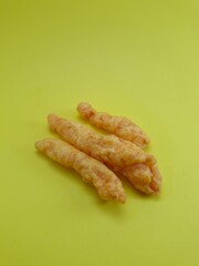 Crunchy salty snack on a yellow background