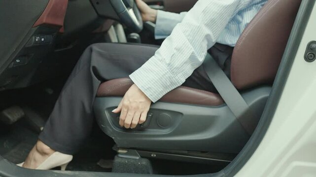 Business woman hand adjust car seat before drive on the road. Ergonomic, health  care and safety transportation concept