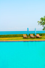 chair pool  or bed pool and umbrella around swimming pool with sea background
