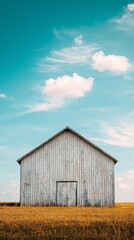 Obraz premium Rustic Wooden Barn Under Bright Blue Sky with Fluffy Clouds