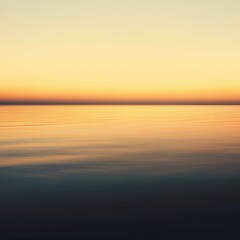 A serene landscape showcasing the calm water reflecting the soft hues of a sunset. The tranquil scene evokes a sense of peace and harmony with nature's beauty.