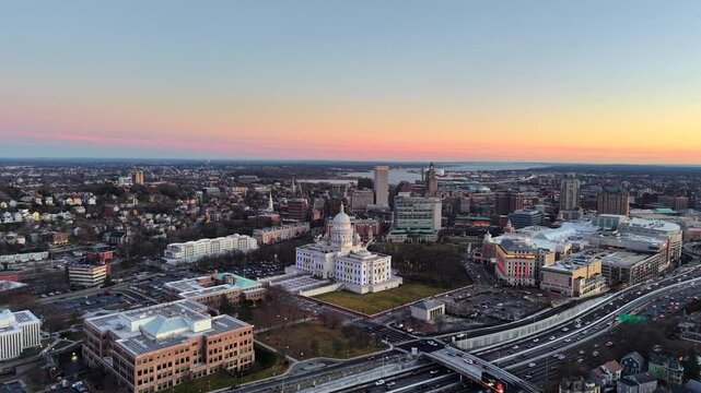 Drone footage of Providence, Rhode Island at dusk with aerial view of the State Capitol Building over interstate I95
