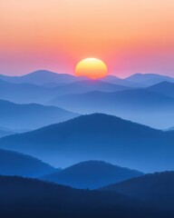 Fototapeta premium Breathtaking sunrise over layered mountain peaks with gentle mist and vibrant colors in a serene landscape
