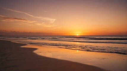 sunset on the beach with waves and a person walking on the sand